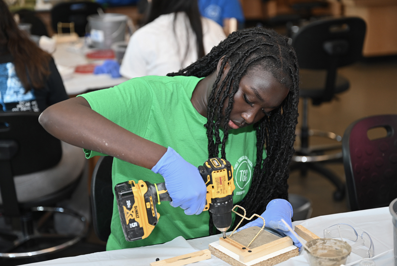 A middle school student uses a drill while completing her concrete coaster she made recently using with materials provided by the Middle Tennessee State University School of Concrete and Construction Management during the during the annual Tennessee Girls in STEM Conference at MTSU Saturday, Sept. 30. (MTSU photo by James Cessna)