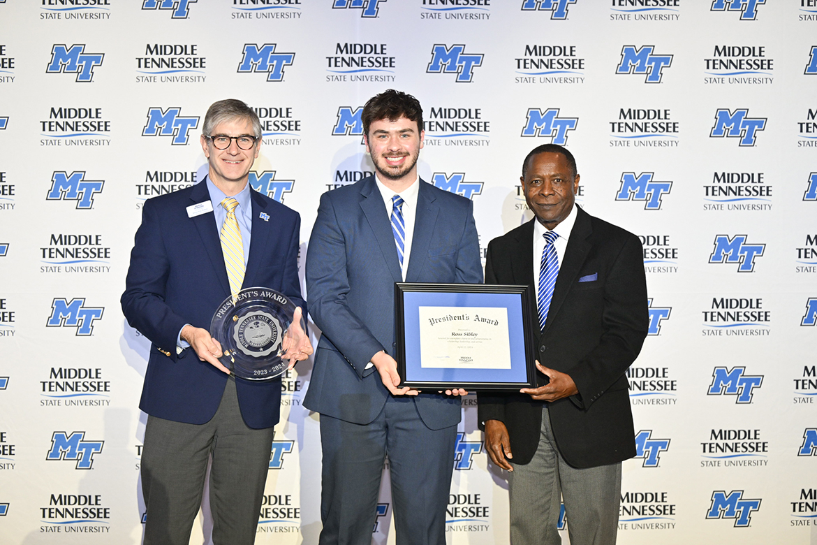 Middle Tennessee State University senior Ross Sibley, center, of Redlands, Calif., shown with College of Basic and Applied Sciences Dean Greg Van Patten, left, and MTSU President Sidney A. McPhee, receives the 2023-24 President’s Award April 22 during the annual Student Government Association and Center for Student Involvement and Leadership Awards Banquet in the Student Union Ballroom in Murfreesboro, Tenn. A biochemistry major, Sibley will be heading to the university of North Carolina-Chapel Hill to pursue his doctorate in chemistry. The student earning this recognition must exemplify superior character and honor and have made achievements that, ideally, all students should strive to meet. (MTSU photo by James Cessna)