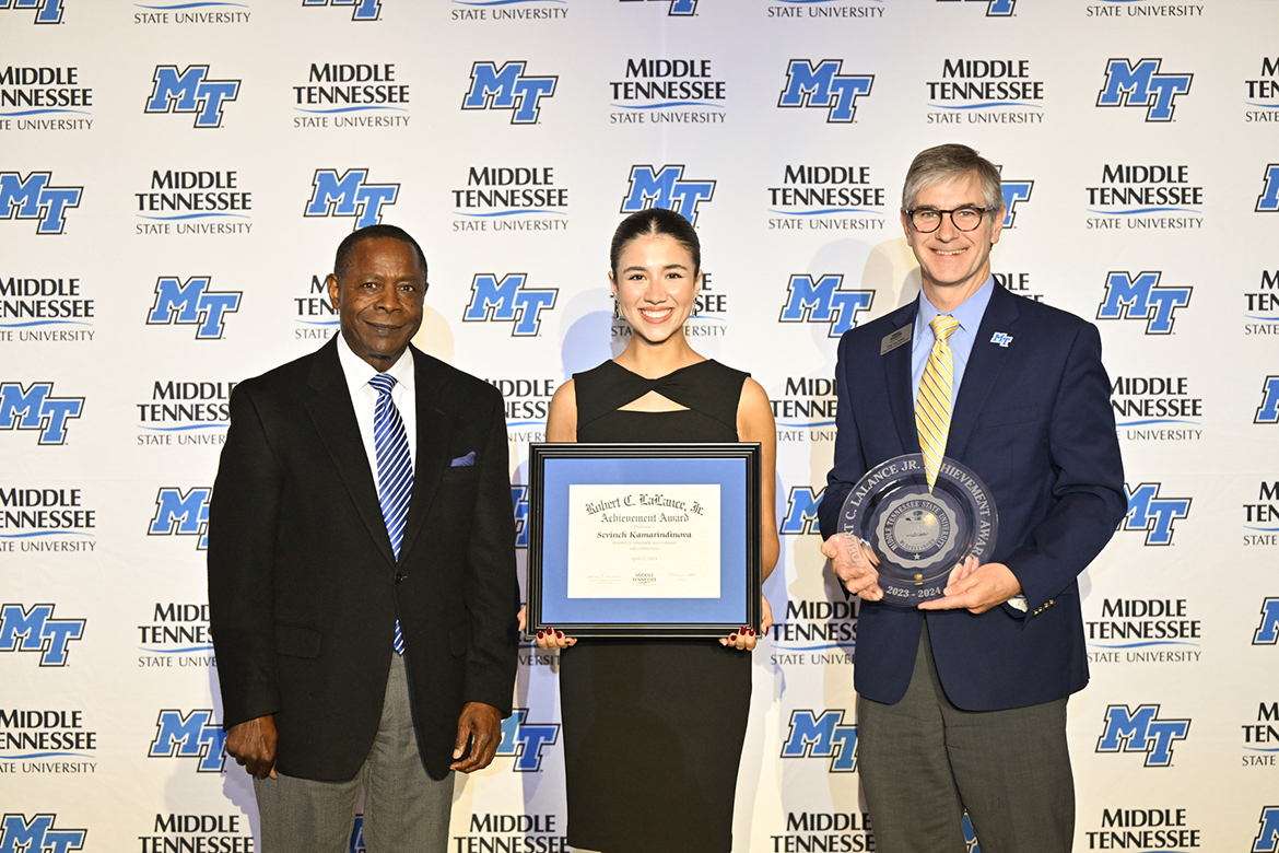 Middle Tennessee State University senior biology (pre-dentistry) major Sevinch Kamaridinova, center, of Gallatin, Tenn., receives the 2023-24 Robert C. LaLance Jr. Achievement Award from MTSU President Sidney A. McPhee, left, and College of Basic and Applied Sciences Dean Greg Van Patten April 22 at the Student Government Association and Center for Student Involvement and Leadership Awards Banquet in the Student Union Ballroom on the MTSU campus in Murfreesboro, Tenn. This award honors a student who has shown remarkable determination, has had to make sacrifices and is contributing to the community while pursuing their degree. (MTSU photo by James Cessna)