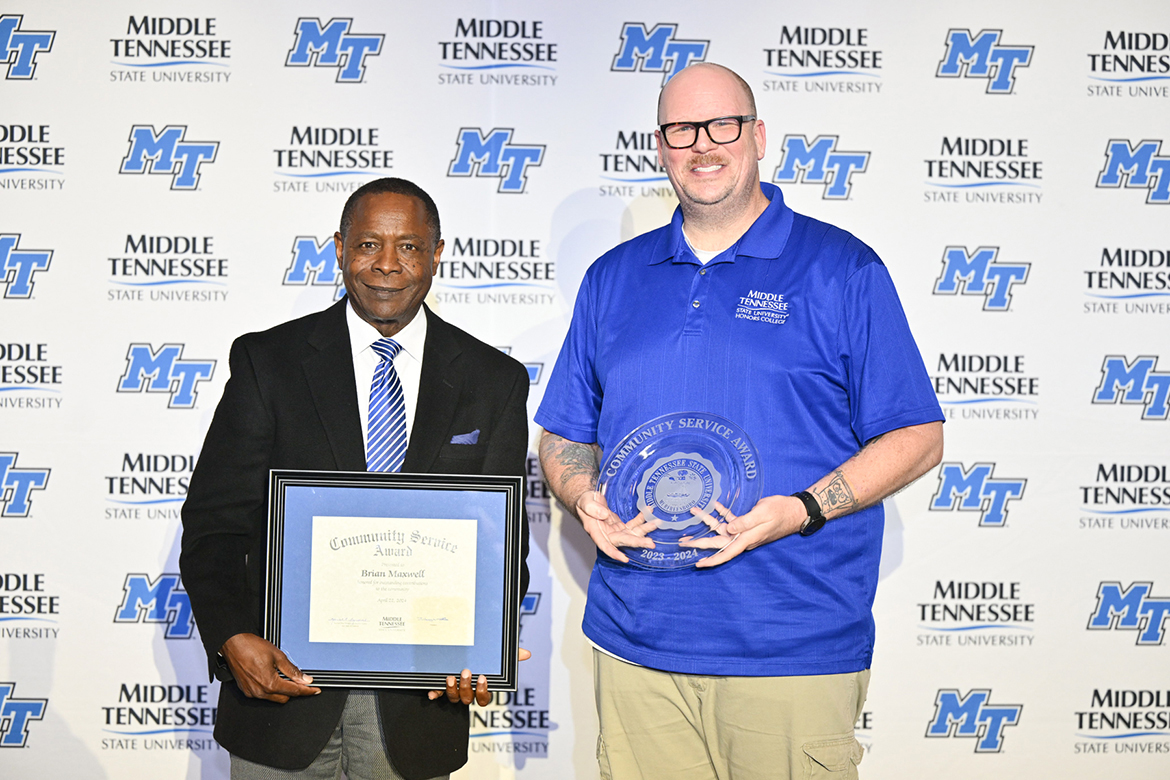 Middle Tennessee State University senior video and film production major Brian Maxwell, right, of Smyrna, Tenn., receives the 2023-24 Community Service Award from MTSU President Sidney A. McPhee April 22 during the annual Student Government Association and Center for Student Involvement and Leadership Awards, held in the Student Union Ballroom on the MTSU campus in Murfreesboro, Tenn. The award is given to a student who exemplifies servant leadership through their service to the campus and off-campus community. (MTSU photo by James Cessna)